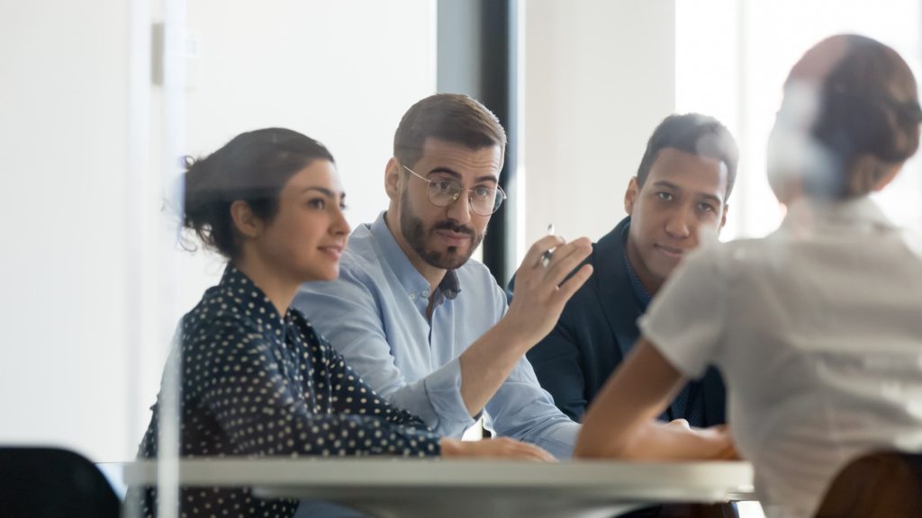 Four people talking in an meeting room
