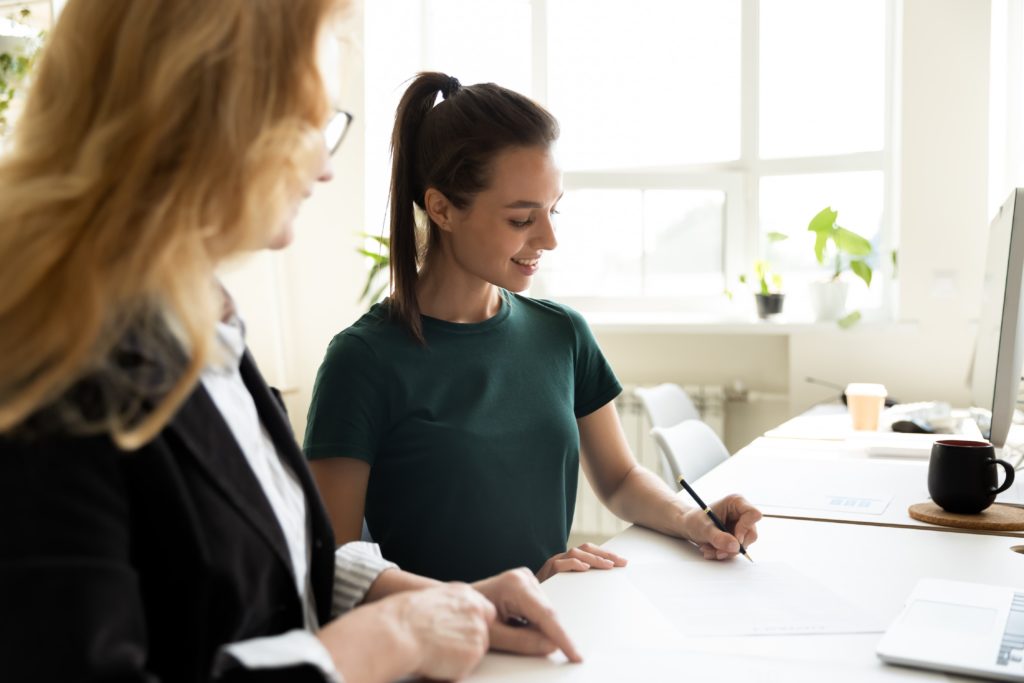 two women working on some papers