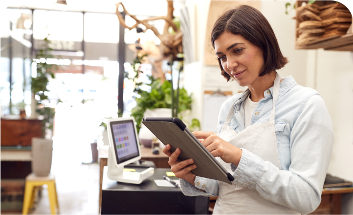 Woman in an apron using tablet.