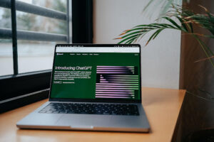 Open laptop with ChatGPT welcome screen.
