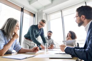 People around a table in a workplace discussing pay transparency
