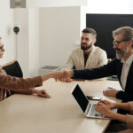 HR Consultants meeting around boardroom table with client